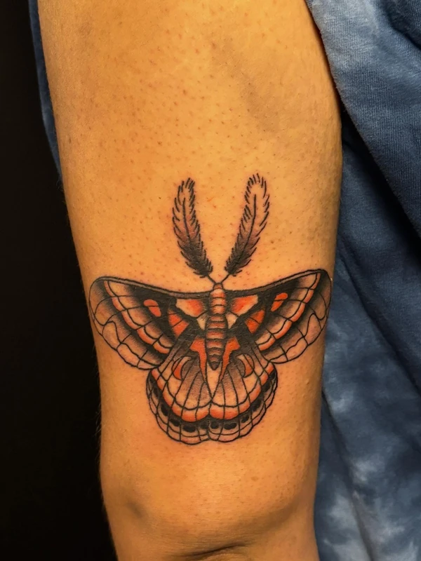 Traditional moth in color, tattooed by Cara