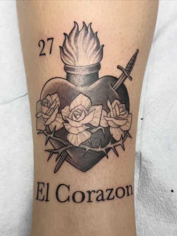 Sacred heart with dagger and roses, tattooed by Tevin